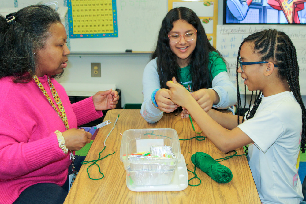 Mount Carmel students and a teacher work on a STEM project at the annual STEM Night.