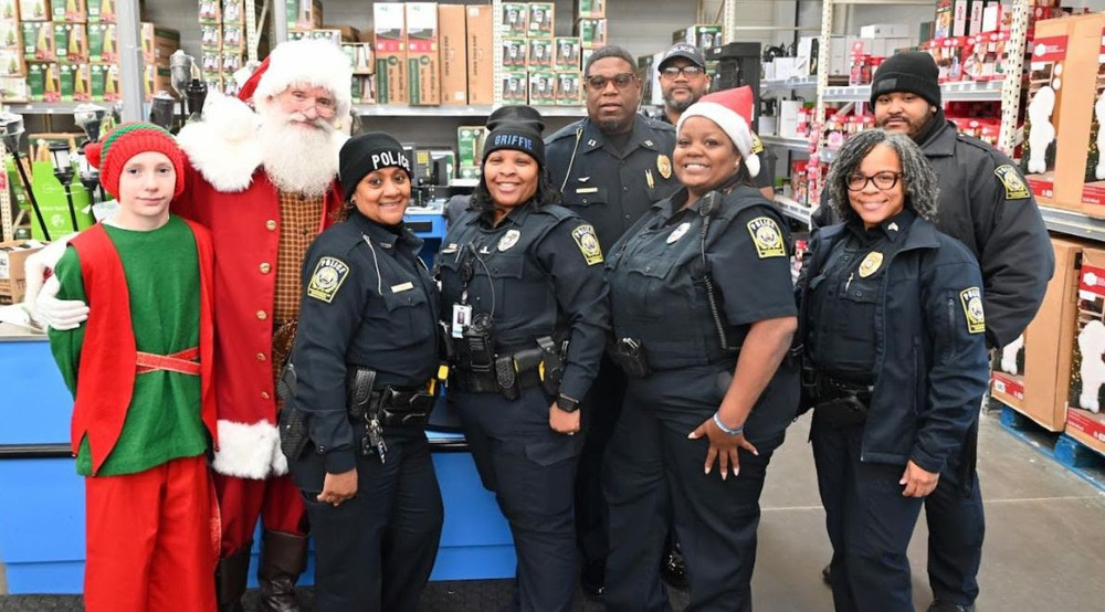 SROs pose with Santa and his elf at the DCSS Police Department Shop with a Cop event.