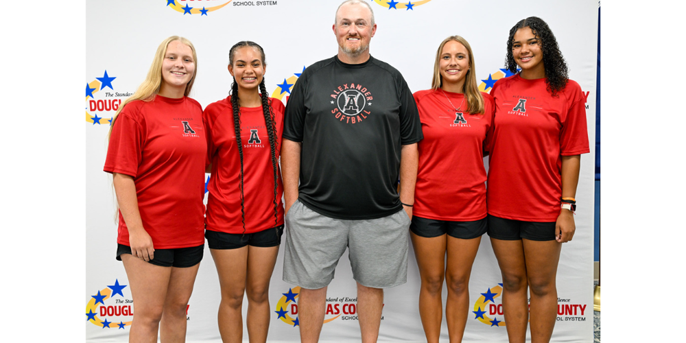 Alexander softball coach Phillip Nasworthy and players in group photo at Media Day.