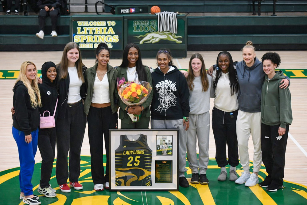 Lithia Springs basketball legend Demeara Hinds is surrounded by players during her jersey retirement ceremony February 6, 2026.