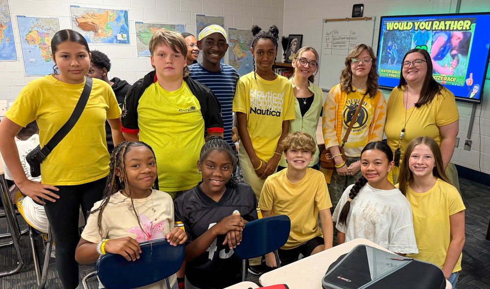 FMS students dressed in yellow for their first House Meeting of the year.