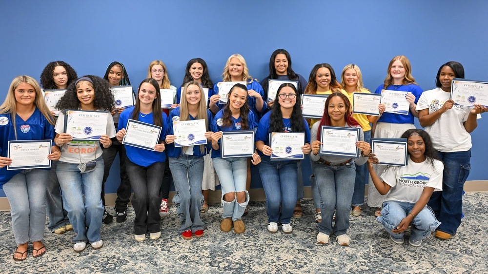 Group photo of all 18 DCSS students who committed to careers in education during the Future Educators Signing Day event.