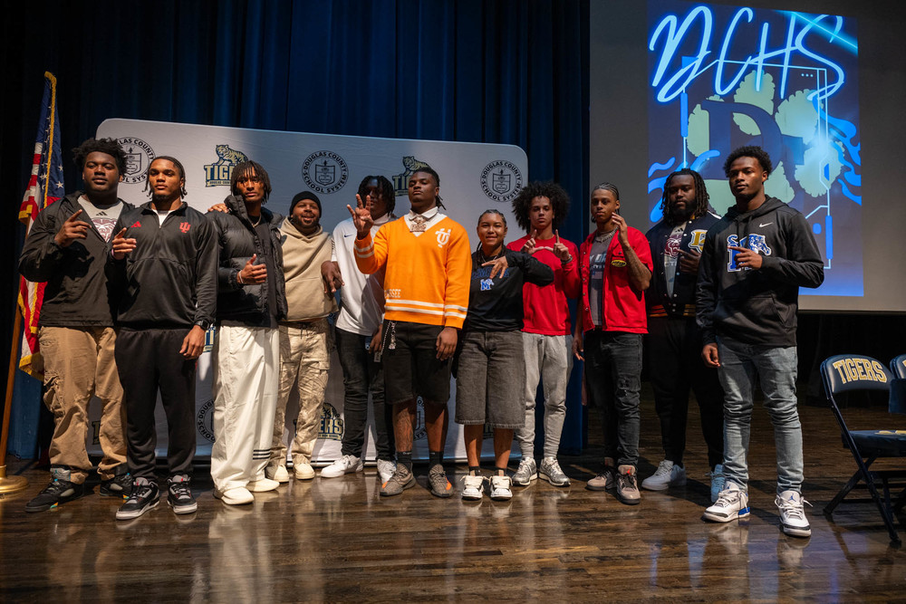 Group photo of DCHS signing college commitments on Dec. 3, 2025.