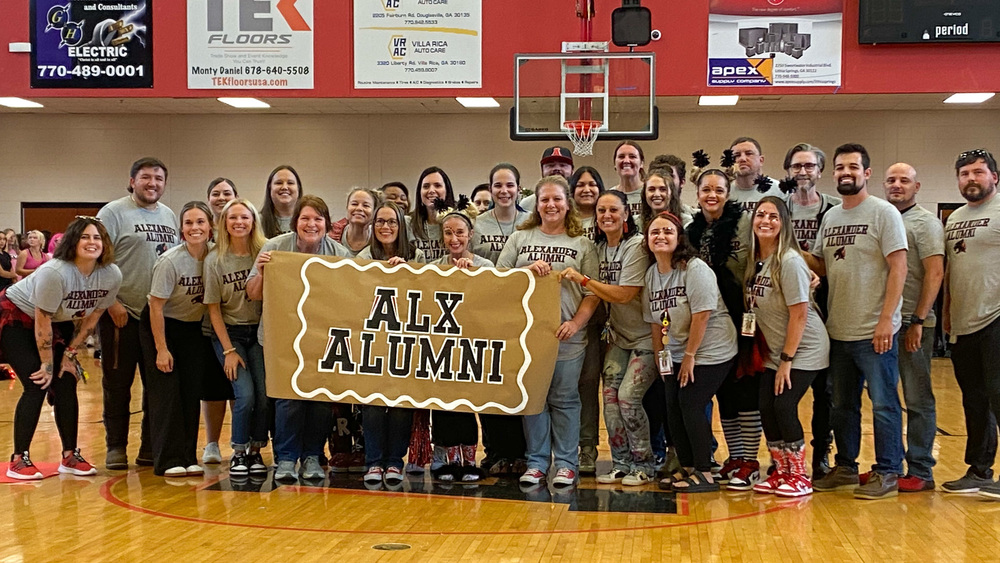 Alexander staff members who are school alumni in a group photo.