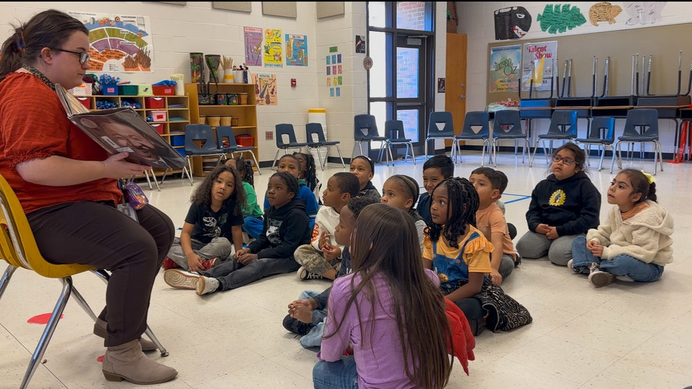 A teacher reads a book to students at Sweetwater Elementary.