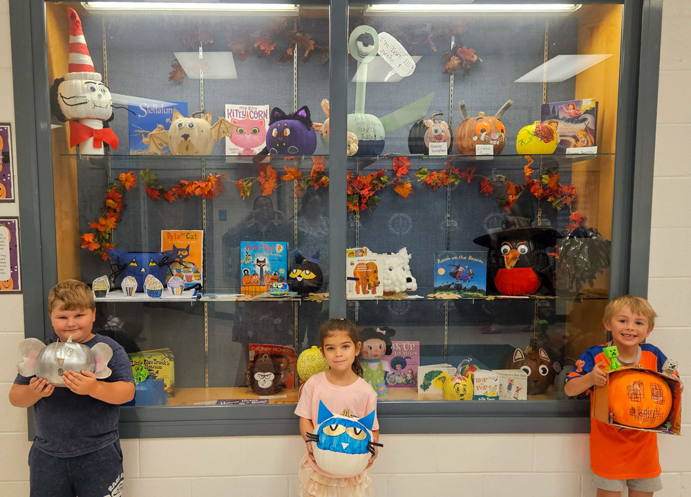 Mirror Lake students hold up decorated pumpkins.