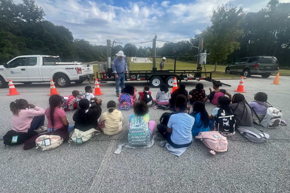 FSES students watch a demonstration by a GreyStone Power employee.