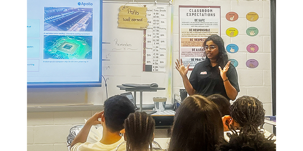 An employee withi Apollo talks to students at Factory Shoals Middle School.