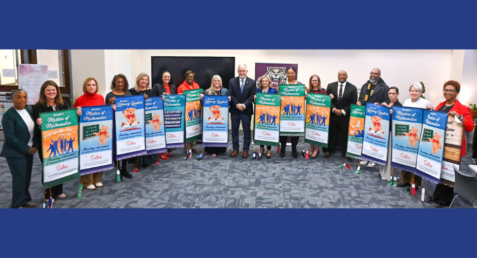DCSS principals hold up their banners for Excellence in Math and Literacy with State Superintendent Richard Woods