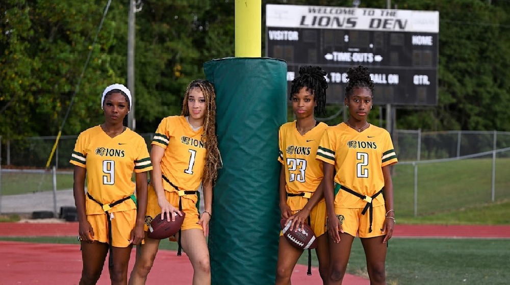 Calayah Montgomery, Leila Essex, Ty Ritman and Jade Linder pose for a feature photo on the LSHS football field.