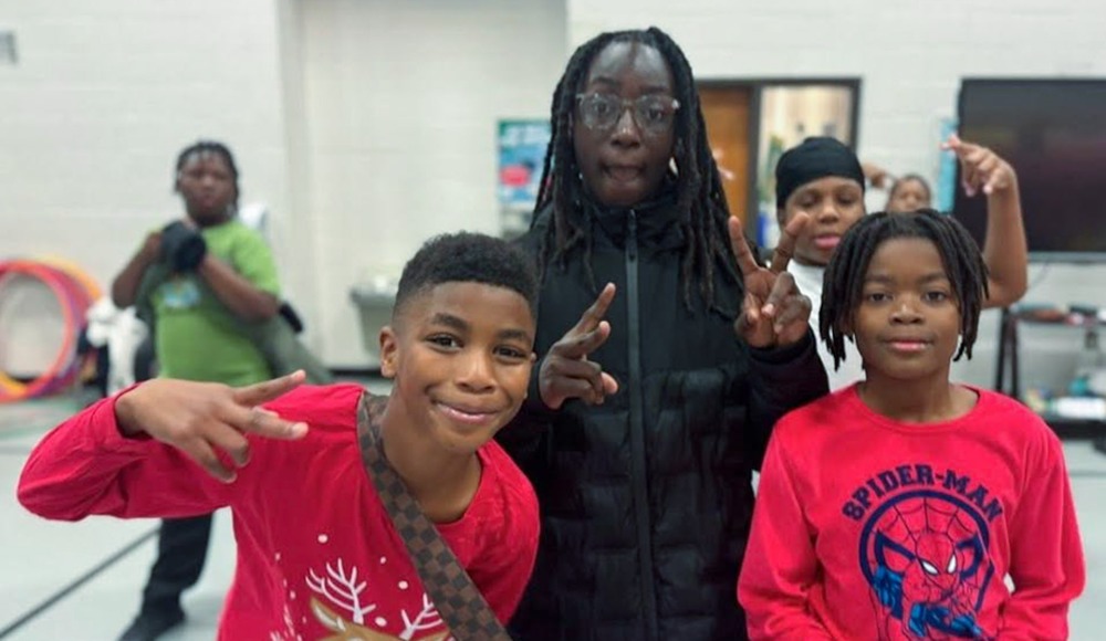Two students and a staff member take part in a Gym Jam at Sweetwater Elementary