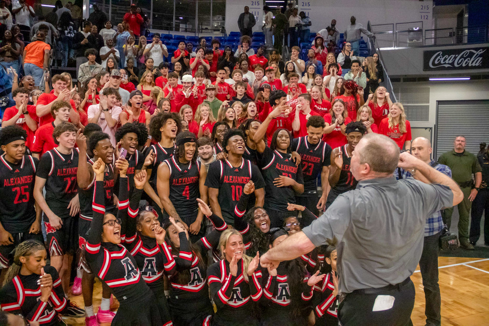 AHS coach speaks to the boys basketball team, cheerleaders and fans after the semifinals win.