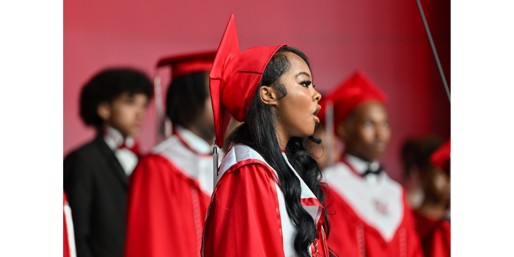 A member of the FAME Chorus is pictured singing at New Manchester High's graduation in 2026.