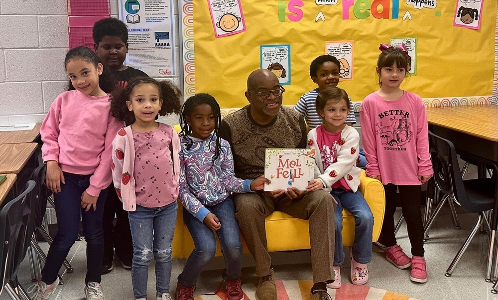 Georgia Literacy Coaching Specialist Dr. Isaac Sparks with Chapel Hill Elementary students during a reading event.