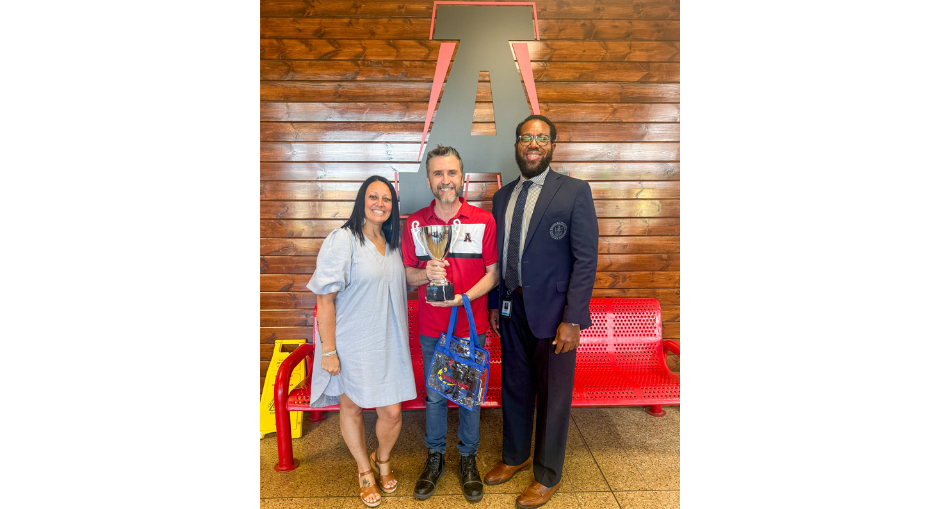 Alexander High counselor Tim Plumley holds up the trophy after being named DCSS Counselor of the Year. Plumley is pictured with AHS Principal Lora McAdams and DCSS Assistant Superintendent of Student Services Dr. Mitch Springer.