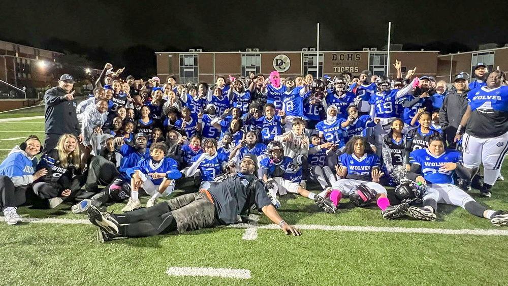 MCMS football team with trophy.