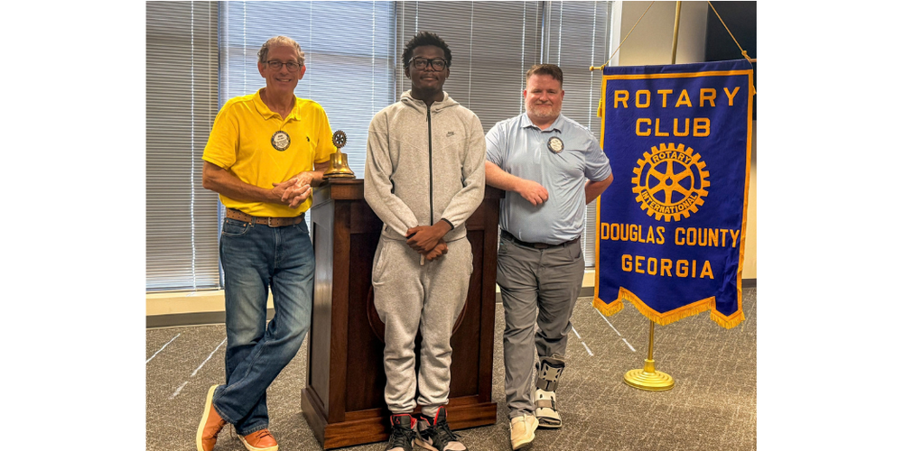 DCHS student Terrique Coker with Rotary officials after Coker spoke about his time at the Rotary Youth Leadership Awards Camp.