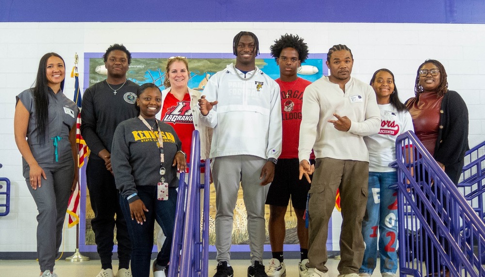 Eight former Chapel Hill students are pictured with counselor Elisa Vaught.