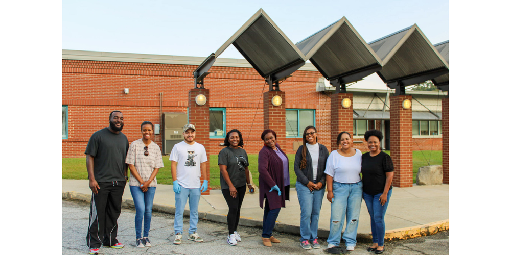Parent volunteers stand in front of Mount Carmel Elementary School.