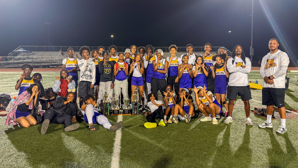 Group photo of Chapel Hill Middle track and field teams with their championship trophies.