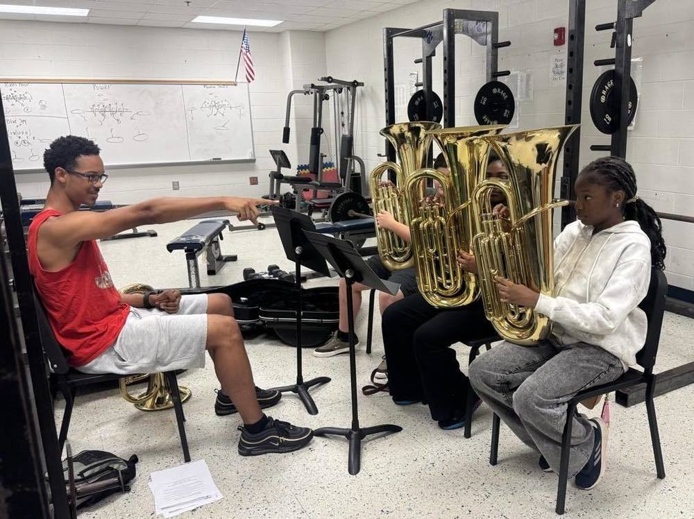 A DCHS student works with MCMS band students