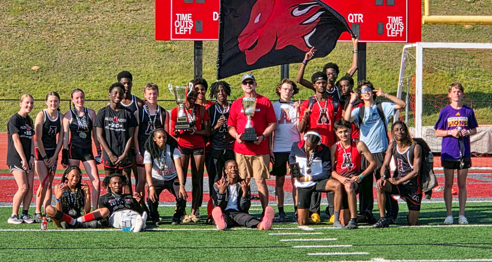 Alexander track coach Jimmy Sorrells and his team with the county championship trophies.