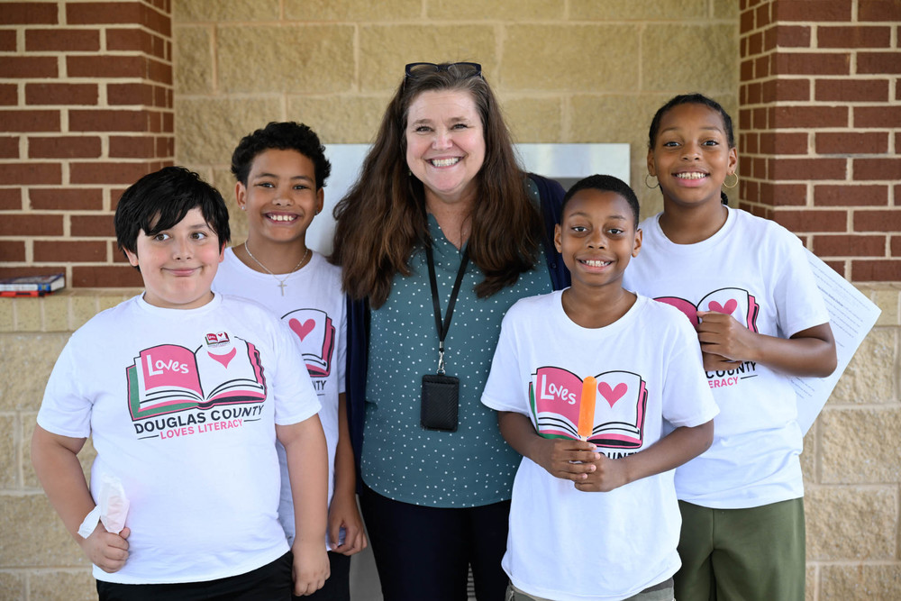 Family Engagement Coordinator Patti Sullivan with Reading Ambassadors at a Summer Reading event.
