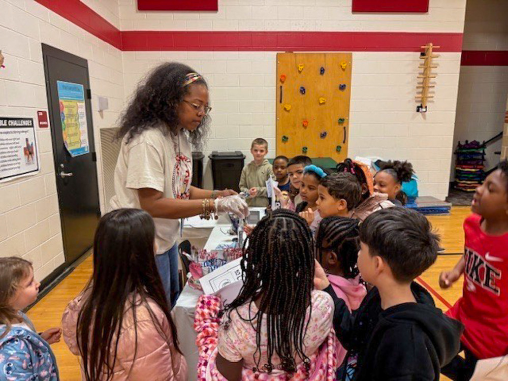 A Winston Elementary staff member passes out food at the "Passport Around the World" event held Jan. 23, 2026.