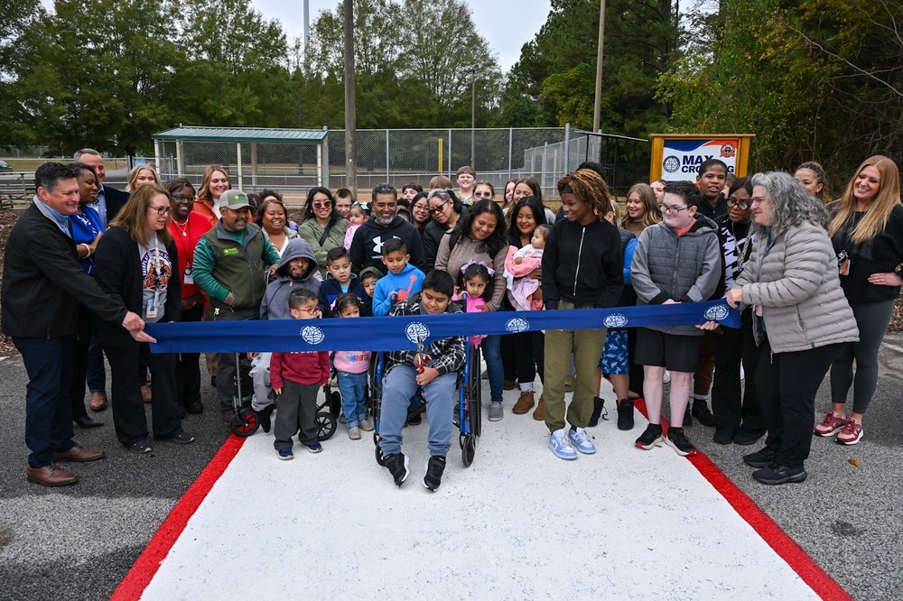 Fairplay Middle eight-grader Max Pachecho Ruiz cuts the ribbon on the new Max Crossing linking the school with Fairplay Park.