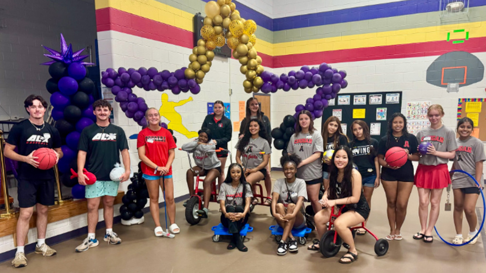 Alexander High students gather for a group photo during Chapel Hill Elementary's Field Day.