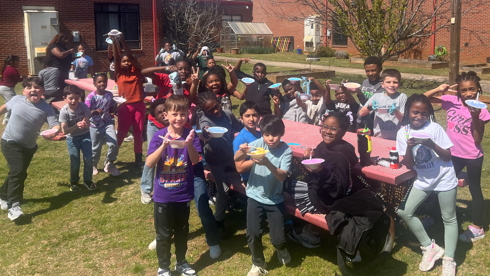 Mirror Lake students play with slime outside at the school.