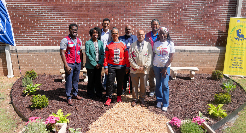 Group photo with New Manchester Principal Casey Bethel and others at the school's new Memorial and Wellness Garden.