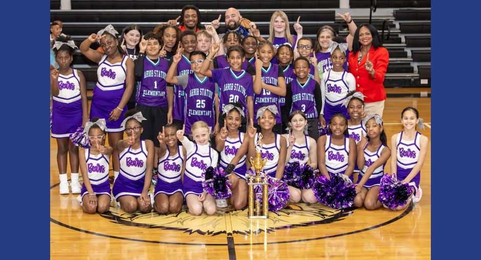 The Arbor Station basketball team, cheerleaders, coaches and Principal Dr. Emily Felton after their win in the county basketball championship.