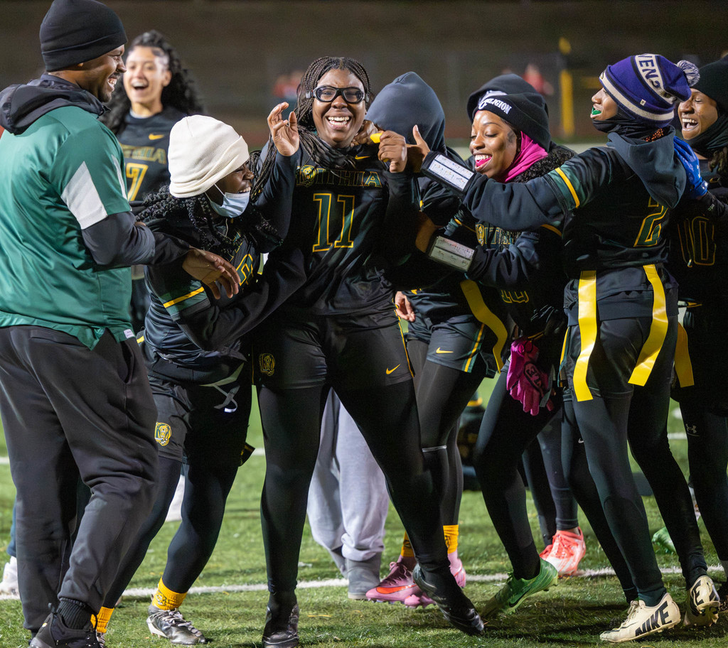 Senior Parker Amenyo celebrates with teammates and coaches after her big interception to seal the Lions' 7-0 win over Brookwood in the first round of the playoffs.