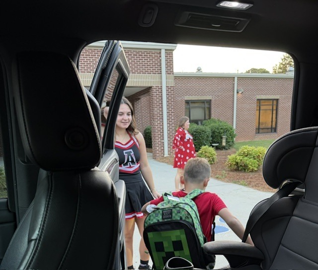 high school athletes help with car riders