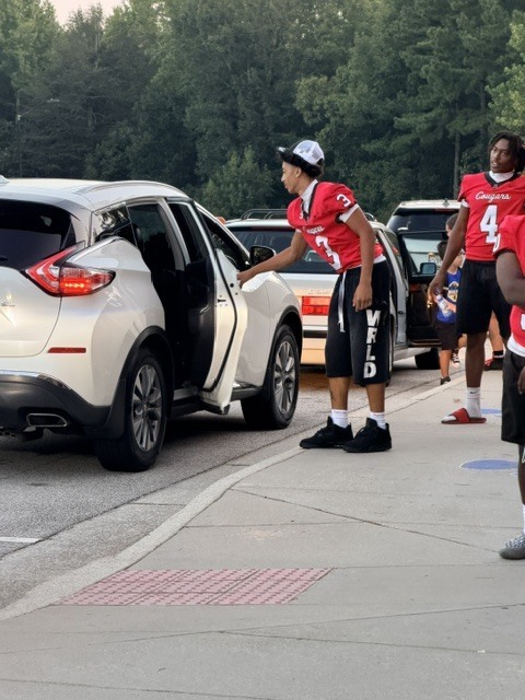 high school athletes help with car riders