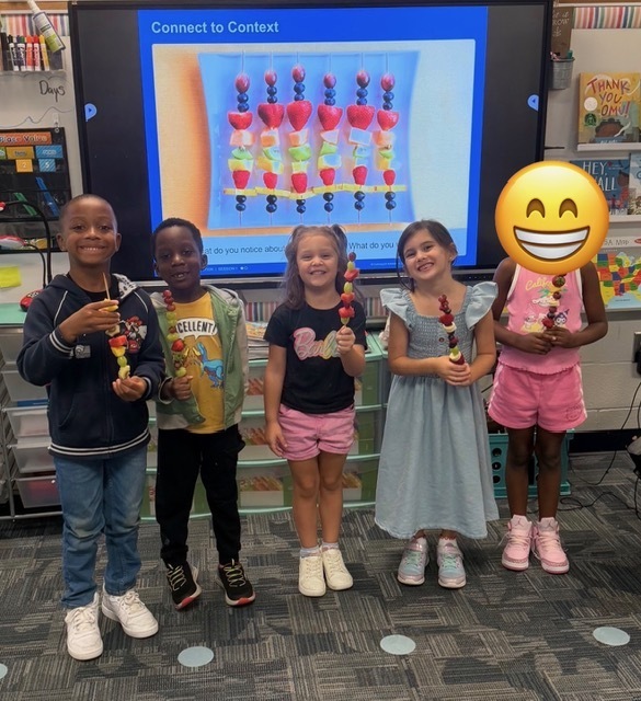 children eating fruit kabobs