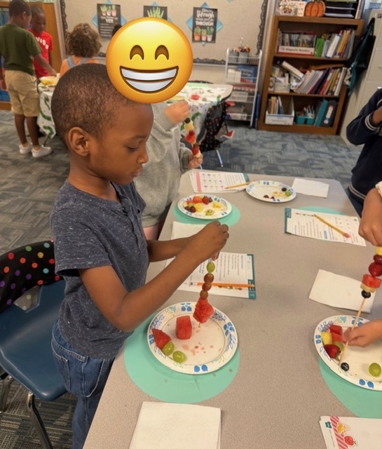 children eating fruit kabobs
