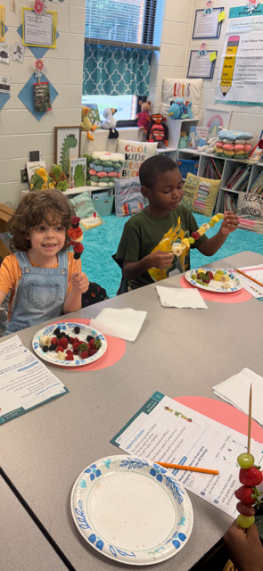 children eating fruit kabobs
