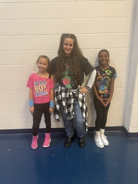 students and staff dressed up for decade day