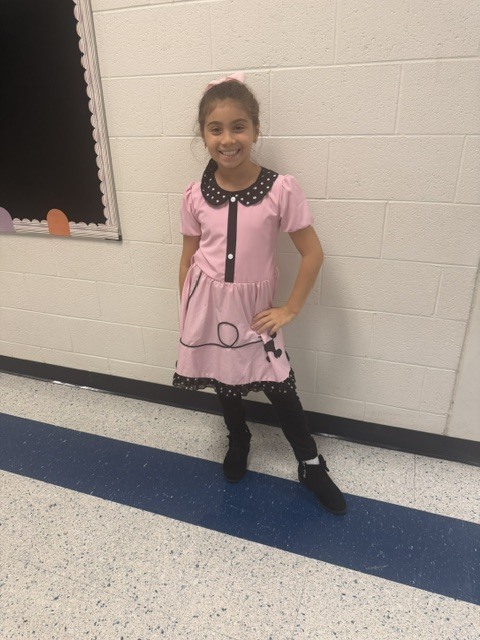 students and staff dressed up for decade day