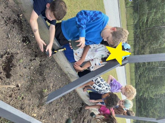 1st grade students planting and watering garden