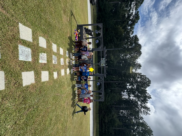 1st grade students planting and watering garden