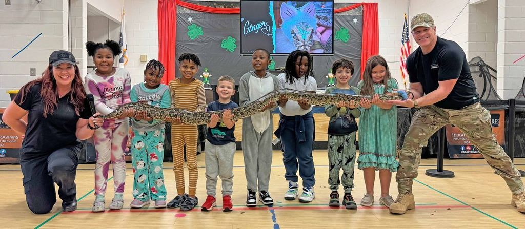 kids holding large snake