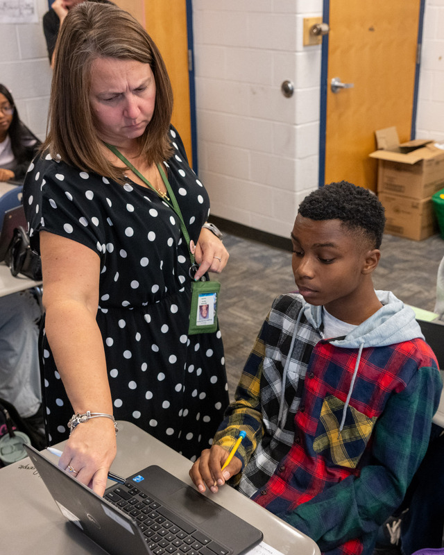 D CHS math teacher Michella Hanna works with a student in her class.