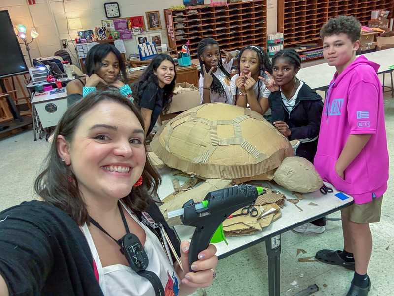 Chapel Hill Middle art teacher Maggie Musa and her students pose with the turtle sculpture they created for the art exhibit.