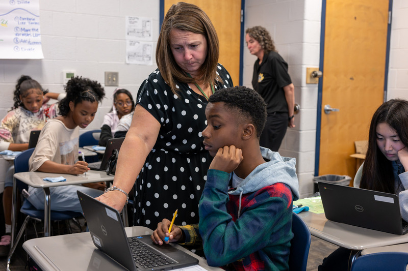 DCHS math teacher Michelle Hanna works with a student in her ninth-grade Algebra class.