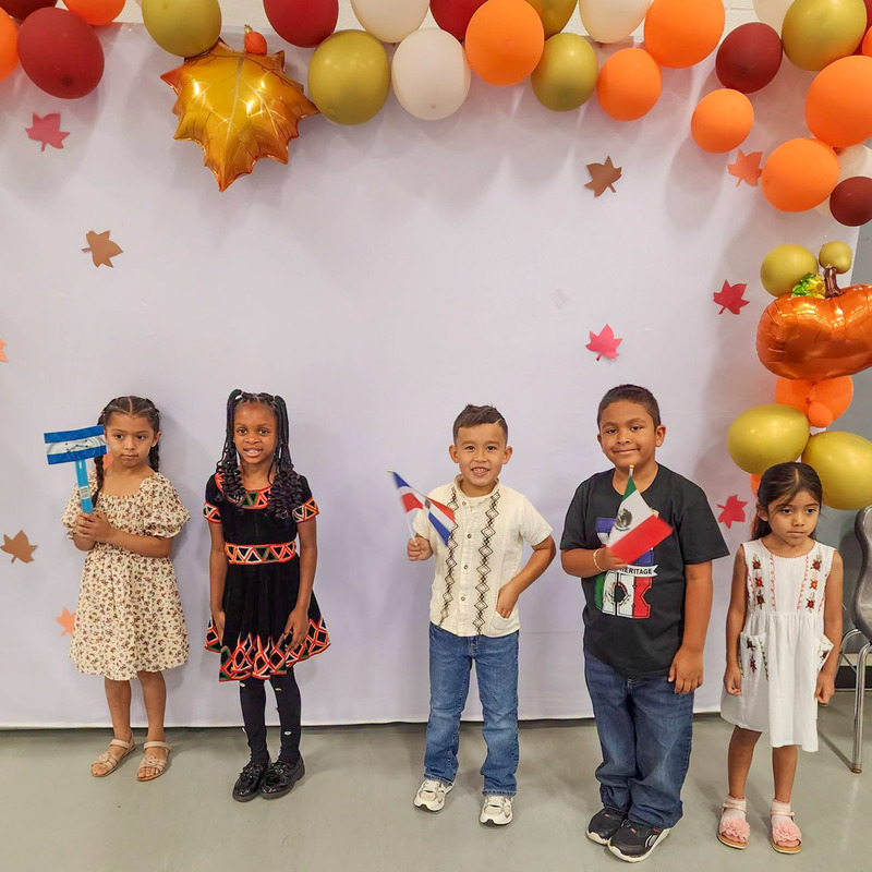 Students at Sweetwater Elementary wave flags from Hispanic countries for Hispanic Heritage Month.