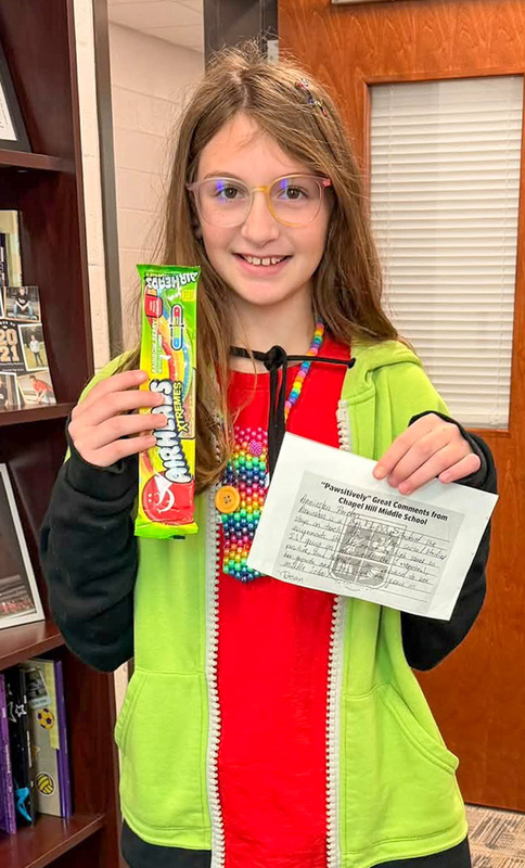 A CHMS student holds up her positive referral card.