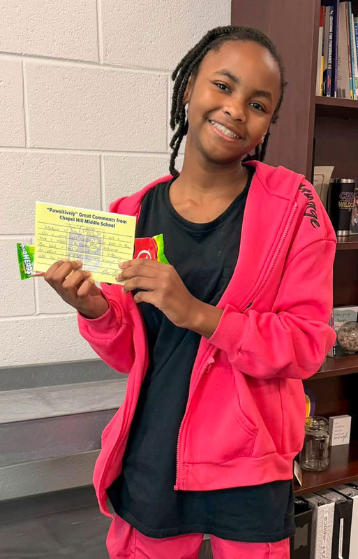 A CHMS student holds up her positive referral card.